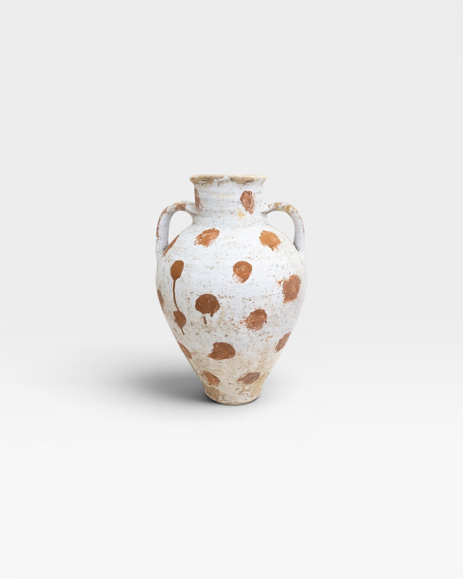 JONES + CO vintage Anatolian polka dot olive jar in white limewash with terracotta slip dots. Hand-thrown in Turkey, aged patina.