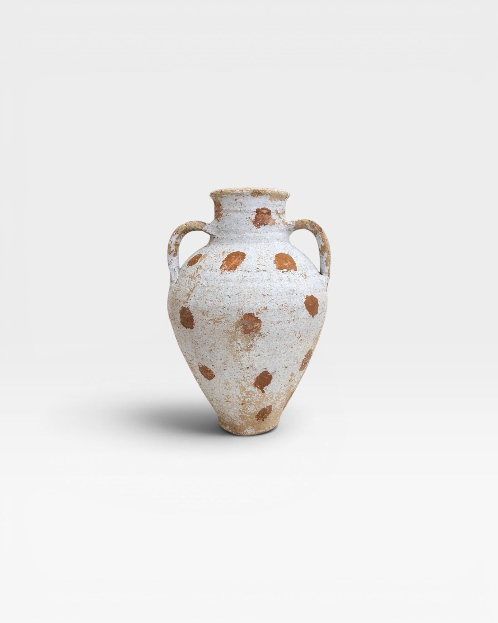 JONES + CO vintage Anatolian olive jar with white limewash and terracotta polka dots. Hand-thrown pottery with aged patina.