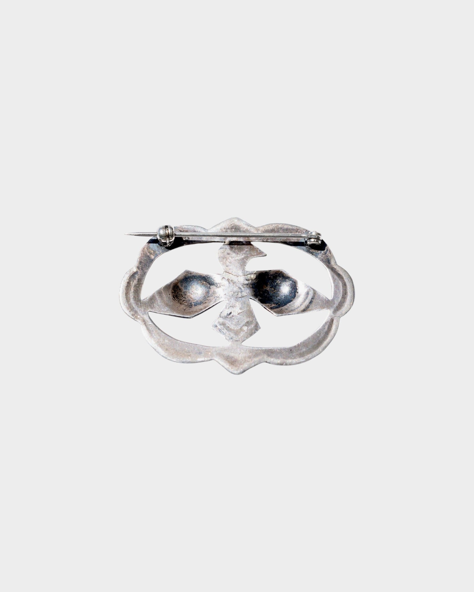 JONES + CO Vintage Navajo Thunderbird brooch in sterling silver and turquoise. Features a detailed thunderbird design.