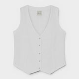 JONES + CO Violette Vest in white heavyweight linen with Italian handcrafted buttons. Sleeveless V-neck vest.