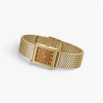 JONES + CO Virgil Small watch in gold with a 20mm rectangular case, ochre dial, and woven mesh bracelet.