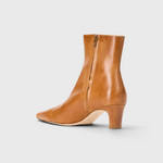 JONES + CO Wally ankle boot in distressed cashew leather with a pointed rectangular toe and slim blade heel.