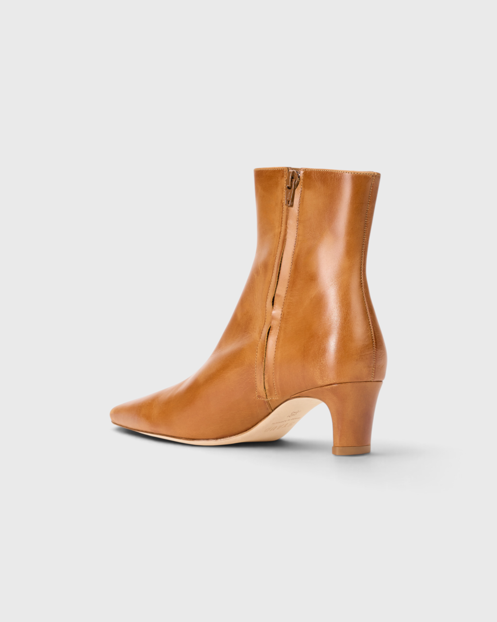 JONES + CO Wally ankle boot in distressed cashew leather with a pointed rectangular toe and slim blade heel.