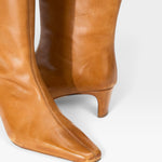 JONES + CO Wally knee-high boots in cashew distressed leather with a pointed toe and slim kitten heel.