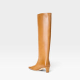 JONES + CO Wally knee-high boot in cashew distressed leather with a pointed toe and slim block heel, side view.