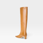 JONES + CO Wally knee-high boot in cashew distressed leather with a pointed toe and slim block heel, side view.