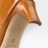 JONES + CO Wally knee-high boot in cashew distressed leather showing the slim heel and sole detail