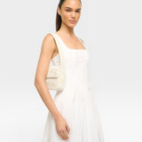 JONES + CO white beaded shoulder bag with 3D floral embellishments and vegan leather piping.