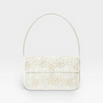 JONES + CO white beaded shoulder bag with 3D floral embellishments and vegan leather piping.