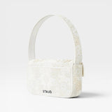 JONES + CO white beaded shoulder bag with floral embroidery and vegan leather trim. Features flap closure and magnetic back pocket.