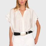 Model wearing a white JONES + CO Trinity button top in lightweight brushed cotton with a relaxed boxy silhouette.