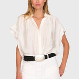 Model wearing a white JONES + CO Trinity button top in lightweight brushed cotton with a relaxed boxy silhouette.