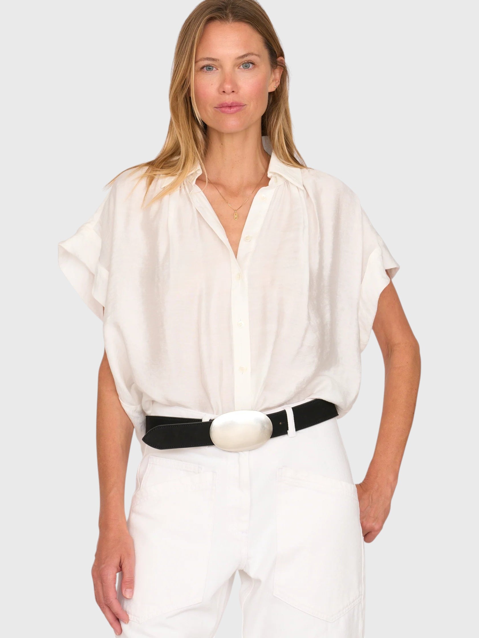 Model wearing a white JONES + CO Trinity button top in lightweight brushed cotton with a relaxed boxy silhouette.