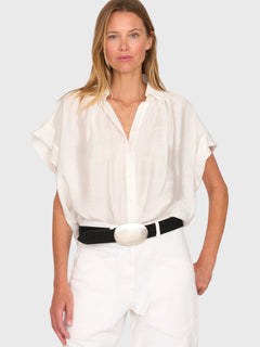 Model wearing a white JONES + CO Trinity button top in lightweight brushed cotton with a relaxed boxy silhouette.