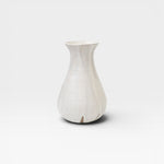 JONES + CO white speckled ceramic bulb vase, handthrown with a flared neck and bulbous base.