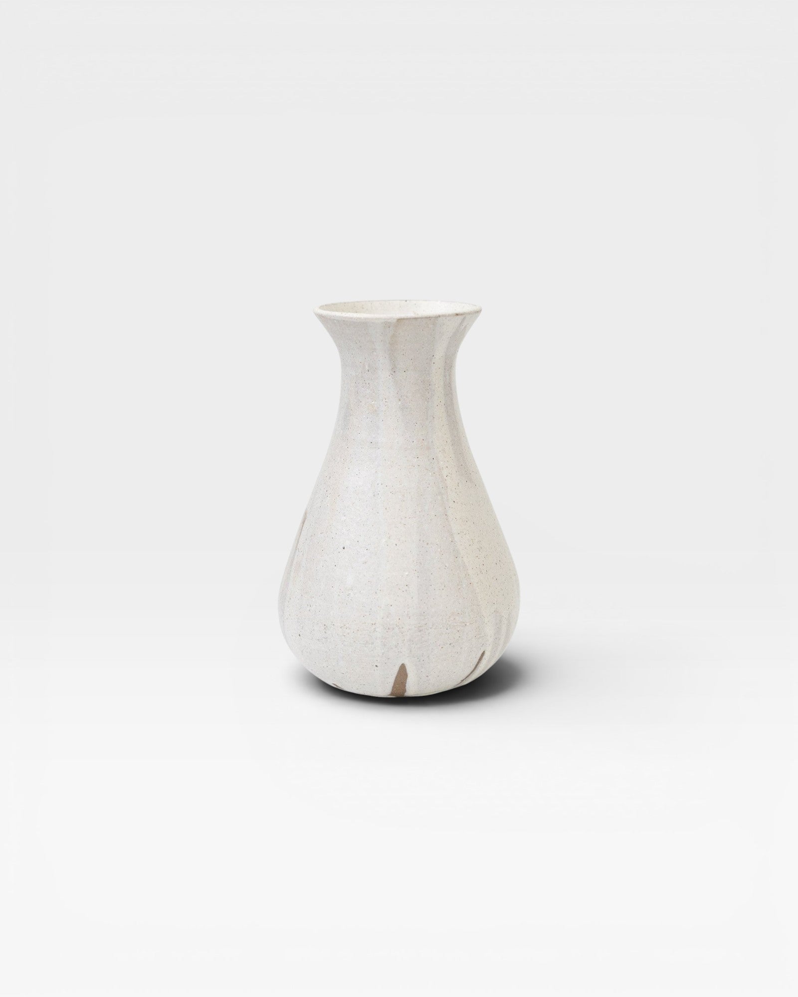 JONES + CO white speckled ceramic bulb vase, handthrown with a flared neck and bulbous base.