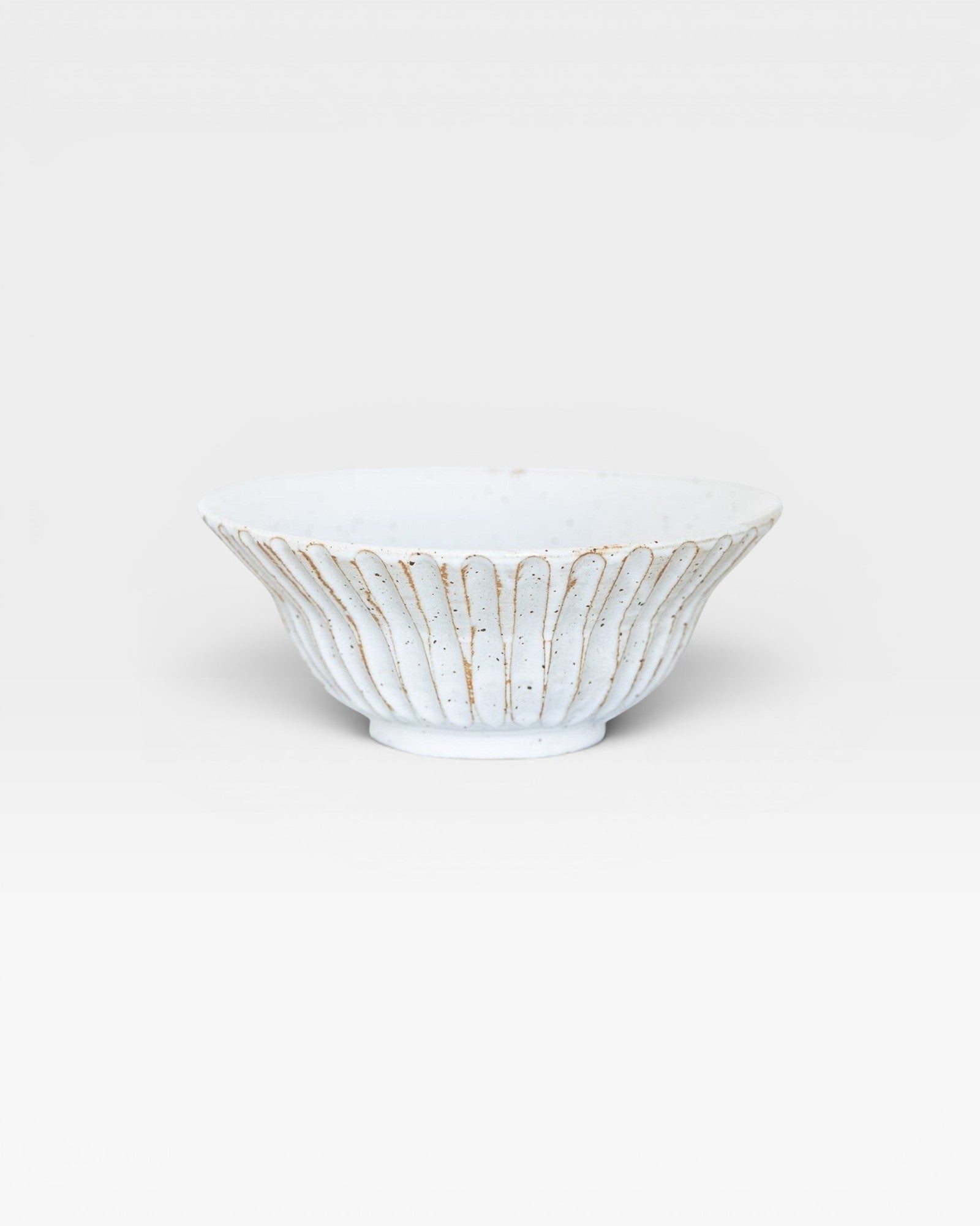 JONES + CO handmade white ceramic large bowl with speckled glaze and fluted design.