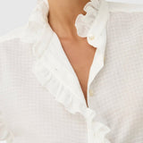JONES + CO white organic cotton voile blouse with tone-on-tone check, ruffles, and mother-of-pearl buttons.