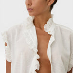 JONES + CO white organic cotton voile sleeveless blouse with tone-on-tone checkered pattern and ruffled trim.