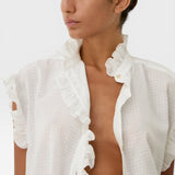 JONES + CO white organic cotton voile sleeveless blouse with tone-on-tone checkered pattern and ruffled trim.