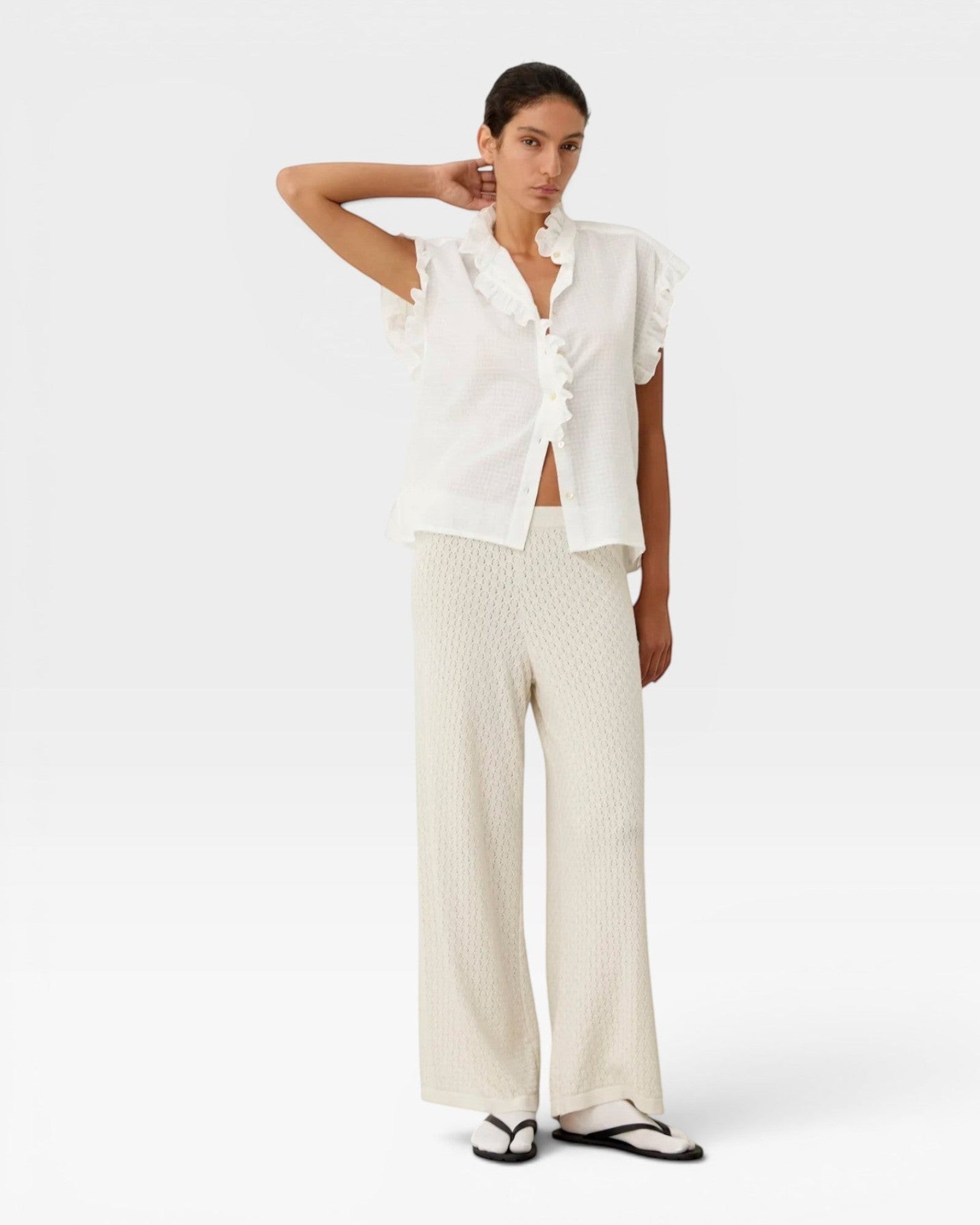 JONES + CO white organic cotton voile sleeveless blouse with tone-on-tone check, ruffles, and mother-of-pearl buttons.