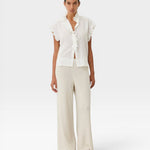 JONES + CO white organic cotton voile sleeveless blouse with tone-on-tone check, ruffles, and mother-of-pearl buttons.
