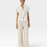 JONES + CO white organic cotton voile sleeveless blouse with tone-on-tone check, ruffles, and mother-of-pearl buttons.