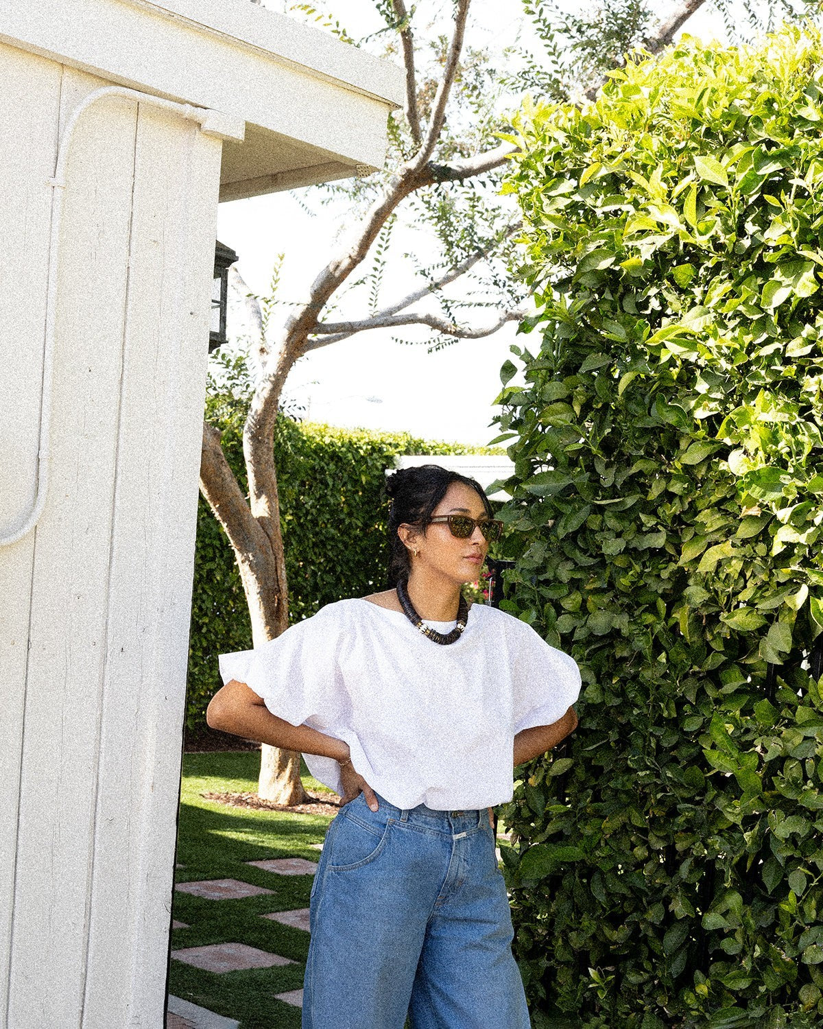 JONES + CO white cotton Coco shirt with boat neckline and dolman sleeves, worn by a woman outdoors.