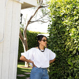 JONES + CO white cotton Coco shirt with boat neckline and dolman sleeves, worn by a woman outdoors.