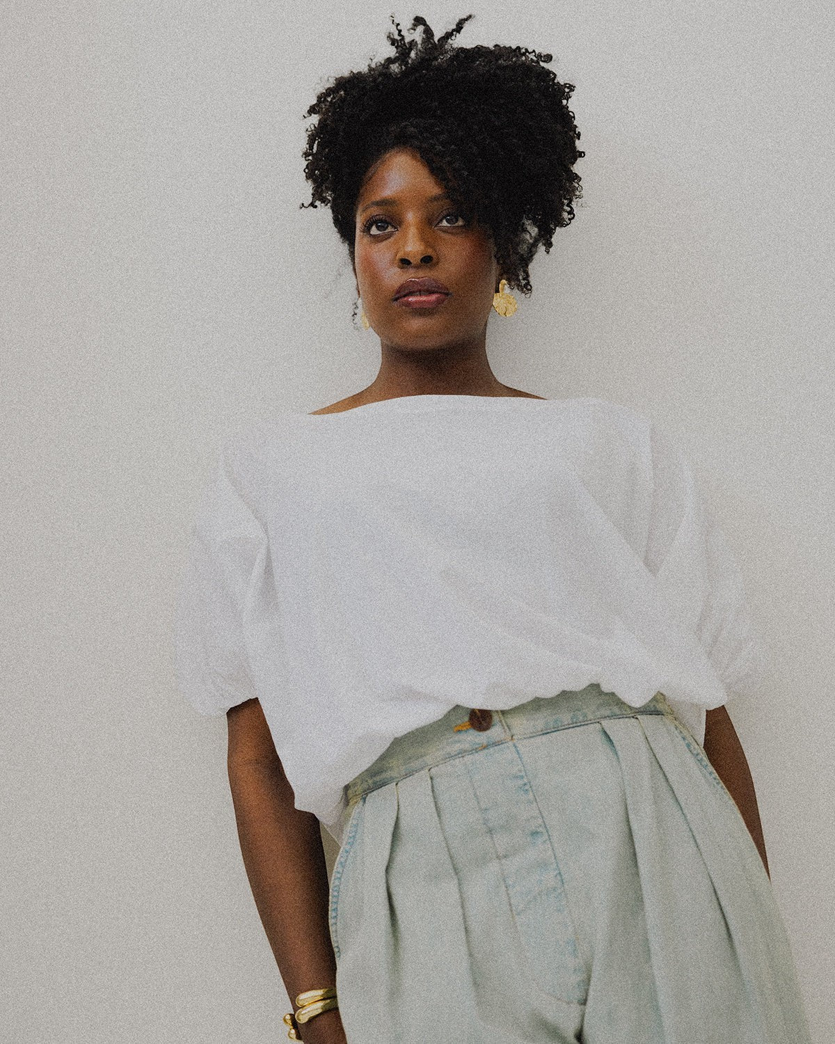 JONES + CO white Coco Shirt with boat neckline and dolman sleeves, paired with light wash pleated denim.