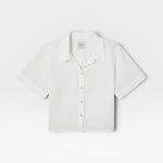 JONES + CO white Anais linen button-down shirt with a minimalist collar and short sleeves in a relaxed cropped fit.