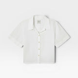 JONES + CO white Anais linen button-down shirt with a minimalist collar and short sleeves in a relaxed cropped fit.