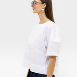 JONES + CO white organic cotton boxy fit rugby top with paneled detail and short sleeves.