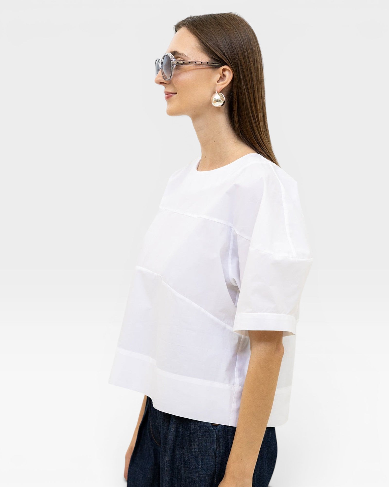 JONES + CO white organic cotton boxy fit rugby top with paneled detail and short sleeves.