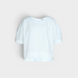 JONES + CO white organic cotton rugby top with a relaxed, boxy silhouette and subtle horizontal seam details.