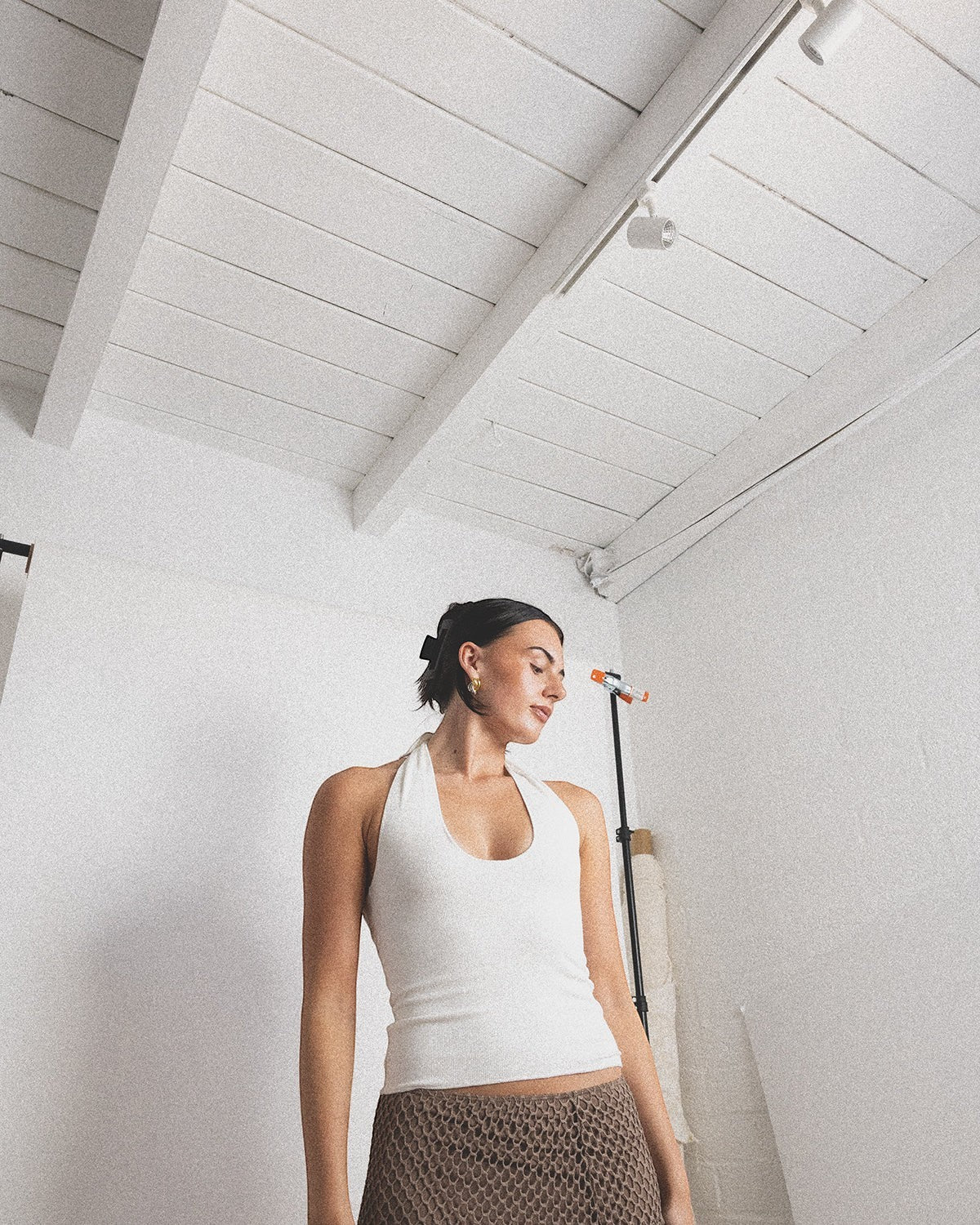 JONES + CO white ribbed halter top with a flattering neckline, paired with a brown crochet skirt.