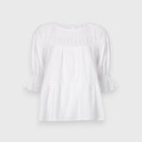 JONES + CO white 100% Pima cotton lawn Sol Top blouse with boat neck, crochet trim, and puff sleeves with ruffled cuffs.