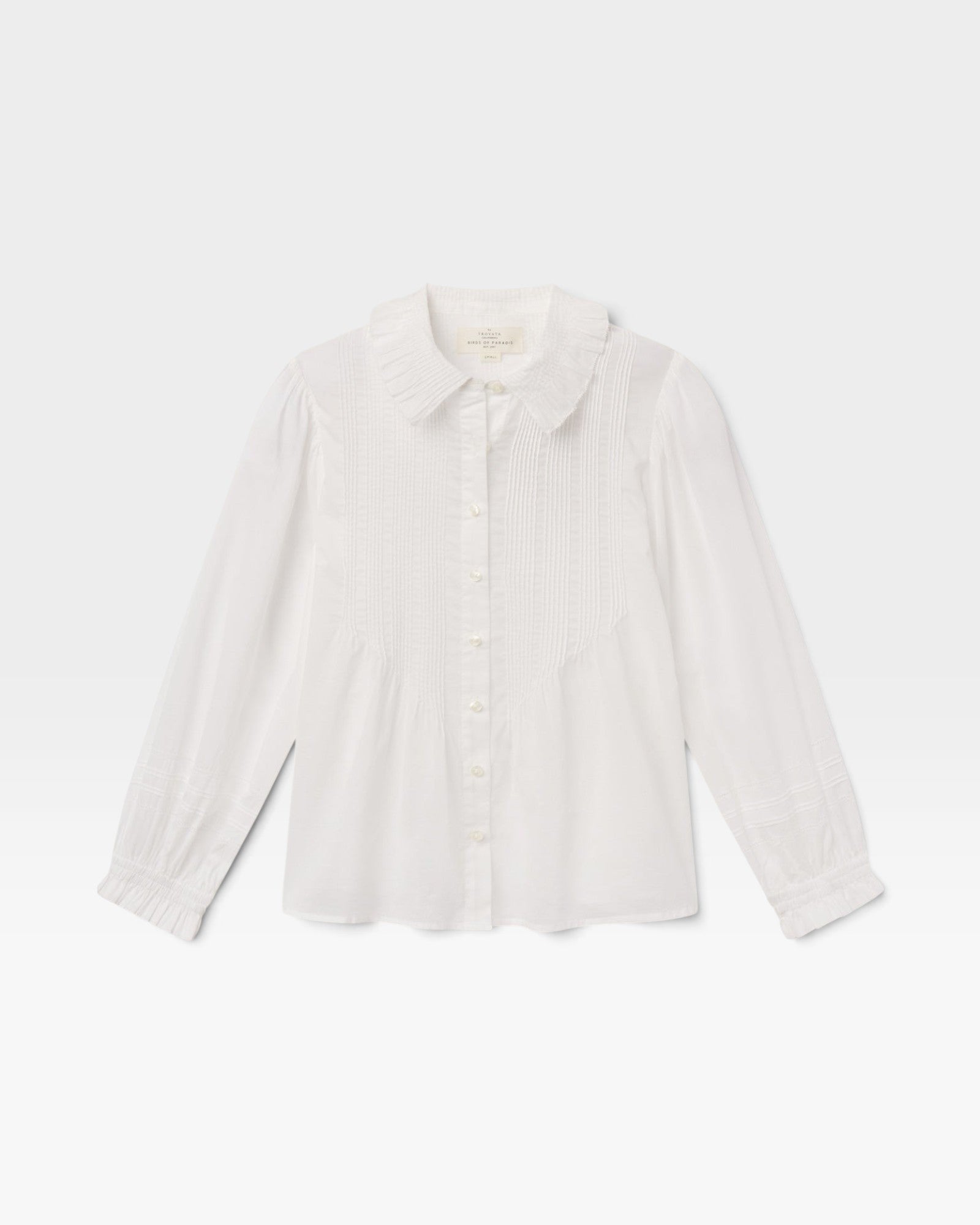 JONES + CO white voile Francesca blouse featuring an oversized point collar, pintucked placket, and ruffled cuffs.