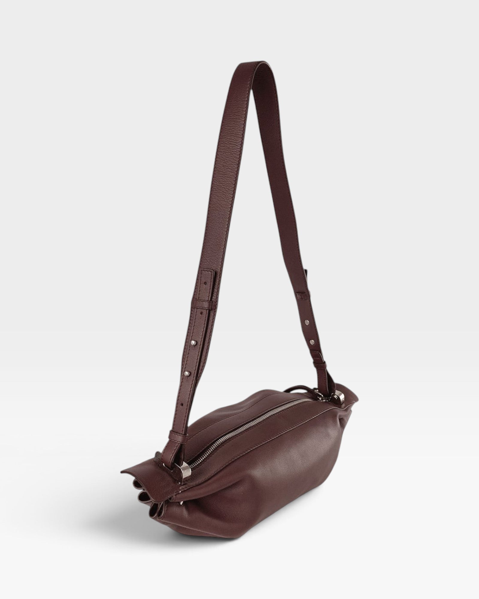 JONES + CO Bon-Bon M wine-colored soft calf leather crossbody bag with pleated ends and silver-tone metal hardware.