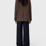 JONES + CO sand beige wool-blend blazer with a blue check pattern, shown from the back on a model in dark jeans.