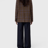 JONES + CO sand beige wool-blend blazer with a blue check pattern, shown from the back on a model in dark jeans.