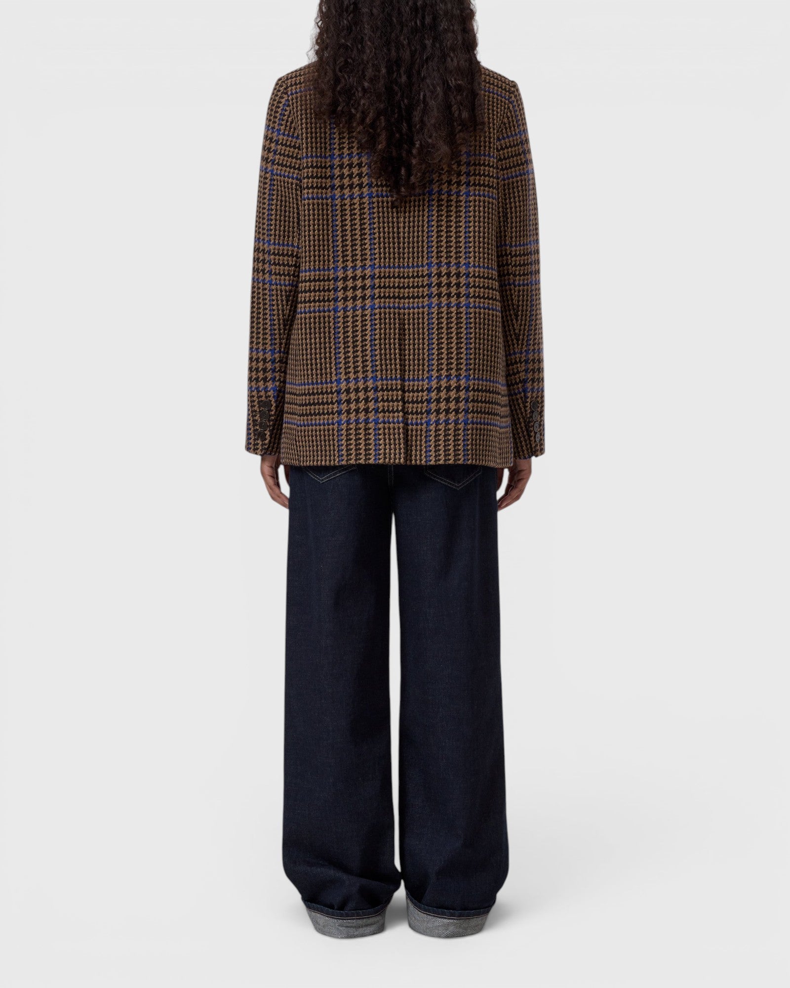 JONES + CO sand beige wool-blend blazer with a blue check pattern, shown from the back on a model in dark jeans.