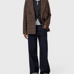 JONES + CO wool-blend double-breasted blazer in sand beige with a blue check pattern, worn over a grey cardigan.