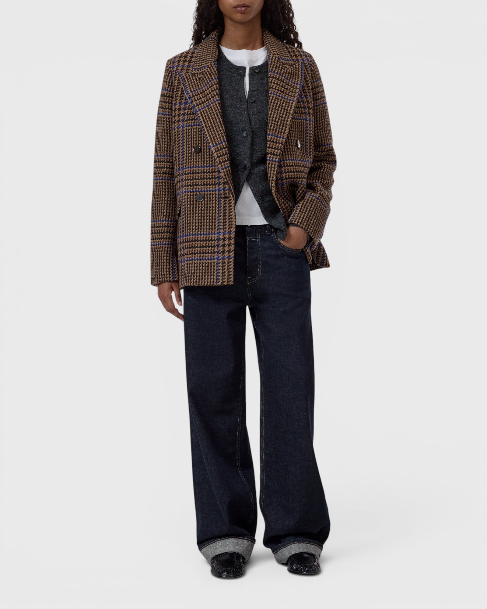 JONES + CO wool-blend double-breasted blazer in sand beige with a blue check pattern, worn over a grey cardigan.