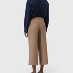 JONES + CO Wren wide-leg cropped trousers in wheat beige wool-viscose flannel, back view on a model.