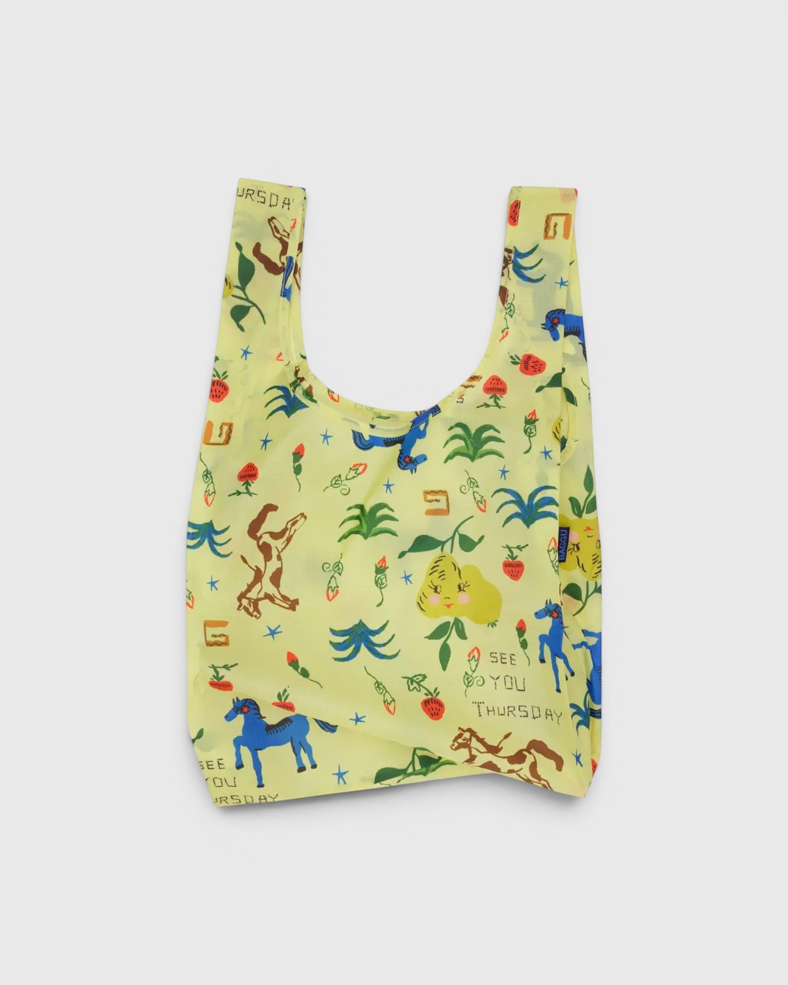 JONES + CO Baggu reusable grocery bag in yellow ripstop nylon with a colorful Painted Prairie print.