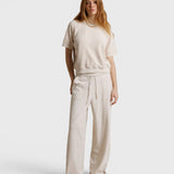 JONES + CO Ziggy short sleeve sweatshirt in sugar cream with raglan sleeves, worn with matching wide-leg trousers.