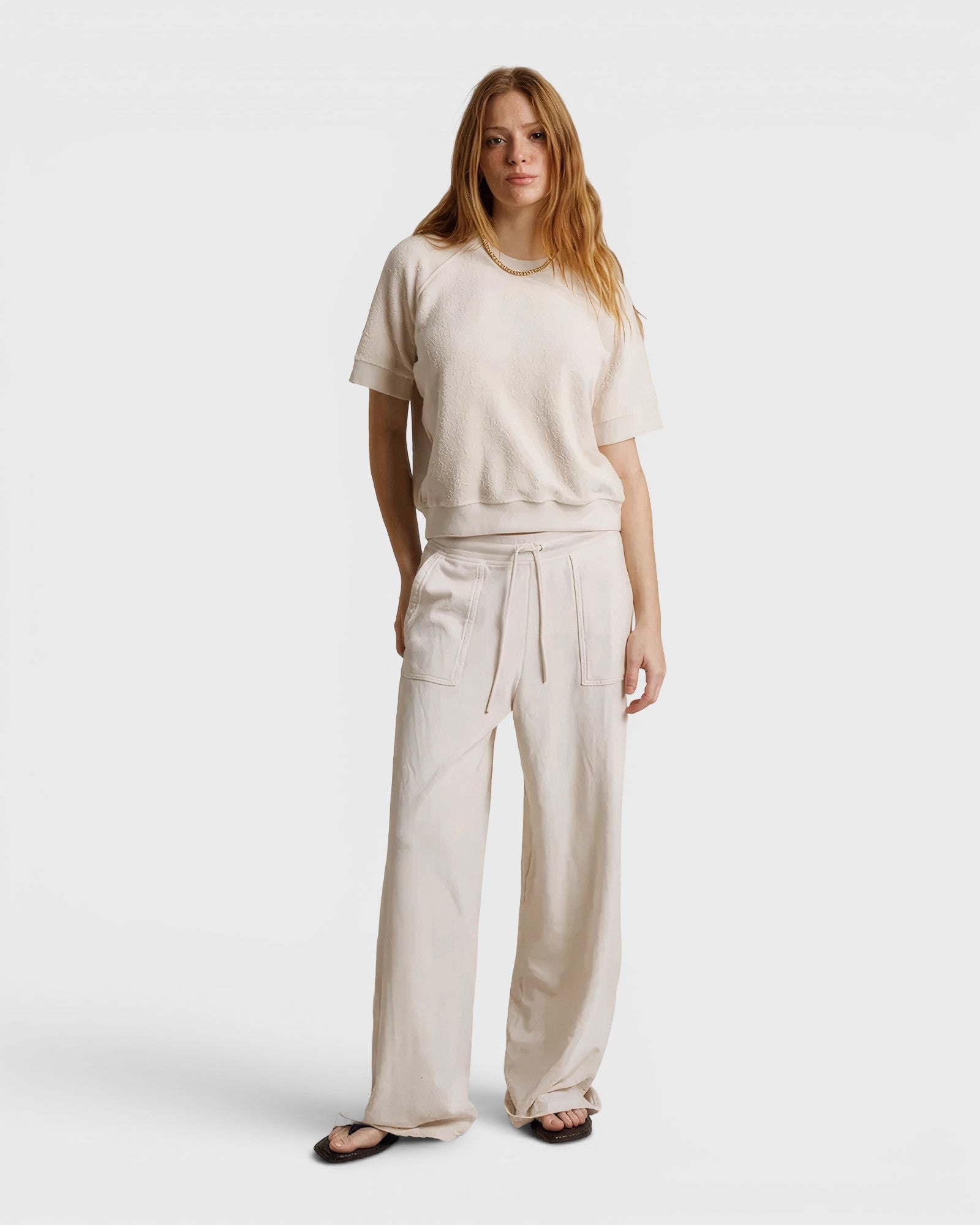 JONES + CO Ziggy short sleeve sweatshirt in sugar cream with raglan sleeves, worn with matching wide-leg trousers.