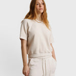 JONES + CO Ziggy short sleeve sweatshirt in sugar off-white with raglan sleeves and a relaxed fit on a model.