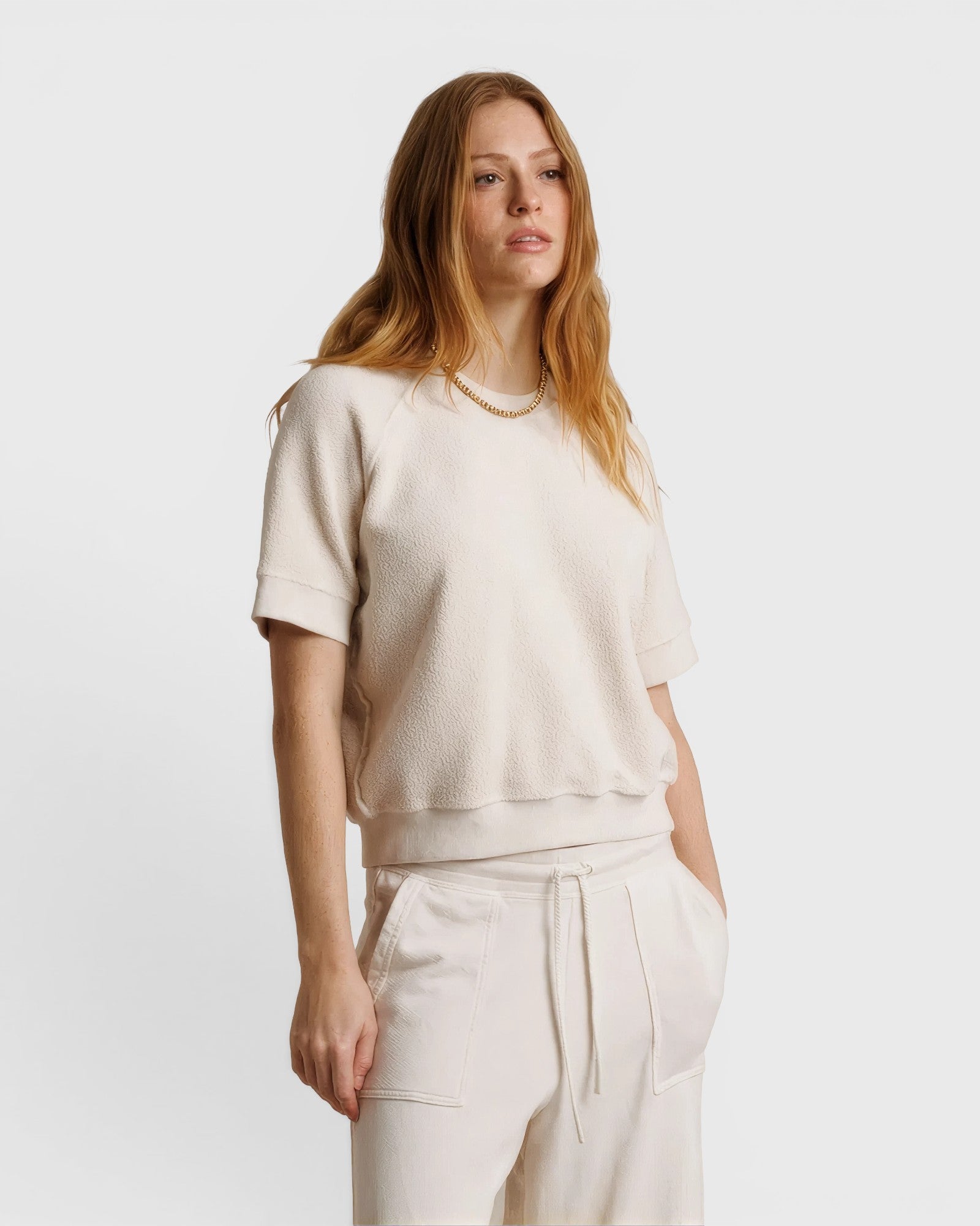 JONES + CO Ziggy short sleeve sweatshirt in sugar off-white with raglan sleeves and a relaxed fit on a model.